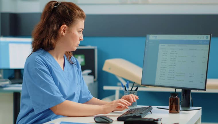 A woman coding a medical exam